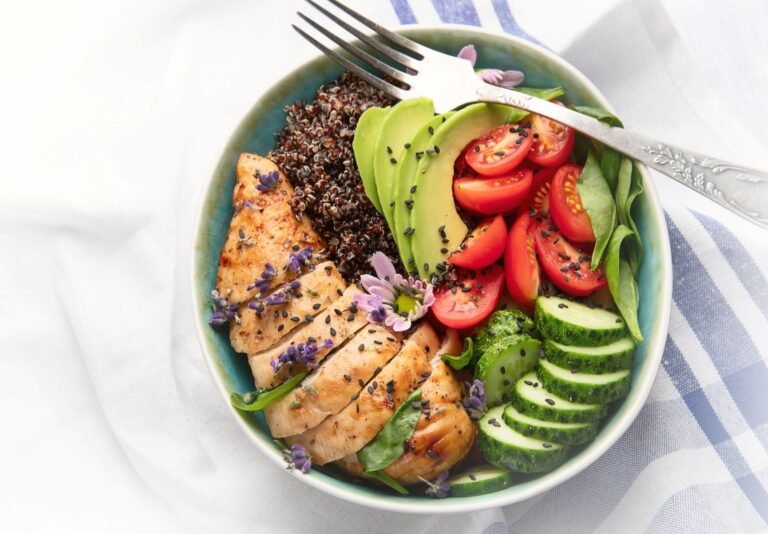 A plate of healthy food, including grilled chicken, quinoa, and vegetables, to support workout performance