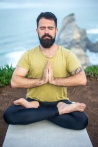 A person practicing mindfulness meditation in a peaceful setting to manage stress.